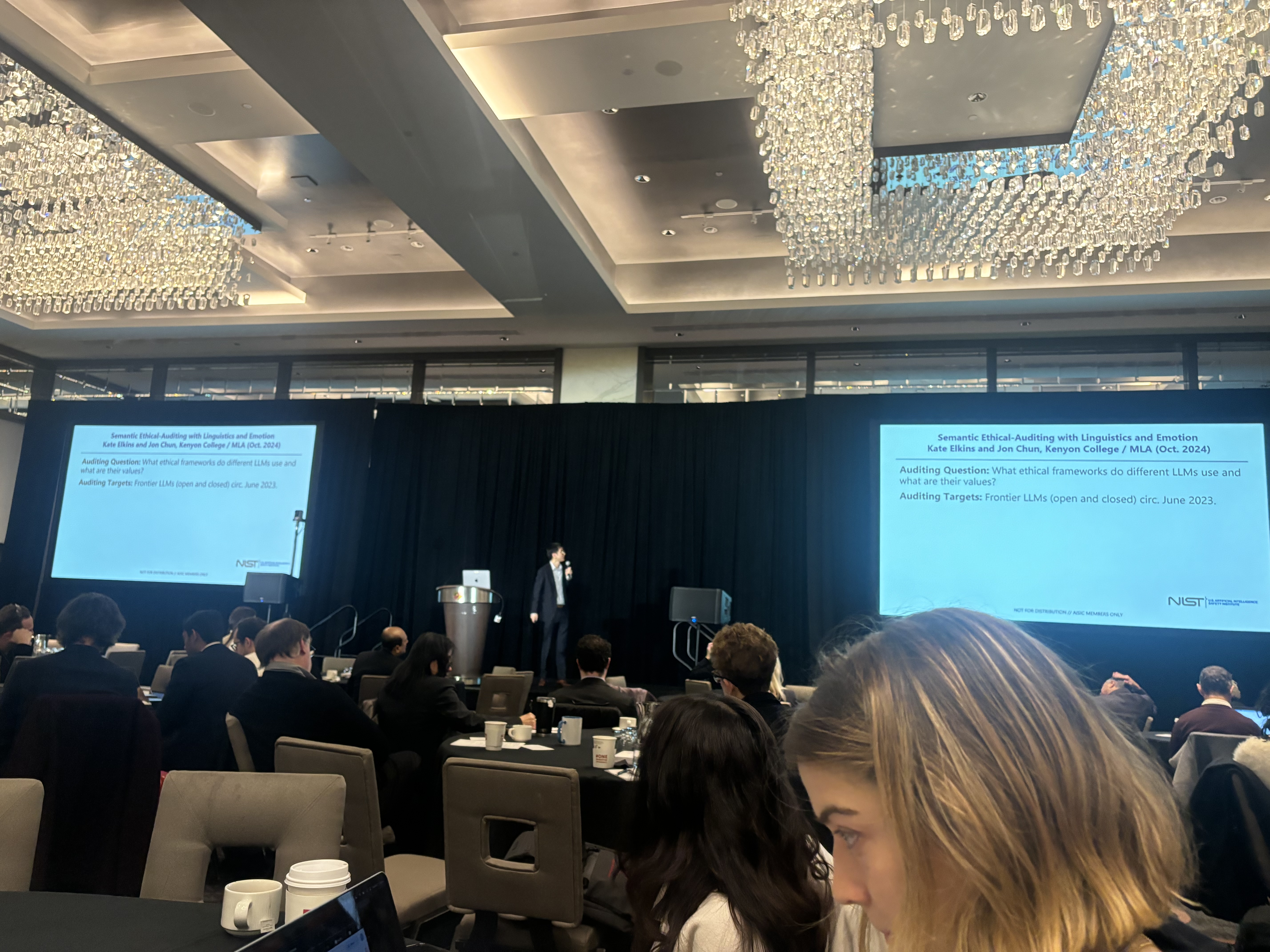Katherine Elkins presenting research at the inaugural NIST AI Safety Institute Consortium plenary, University of Maryland, December 2024. With Tony Wang.